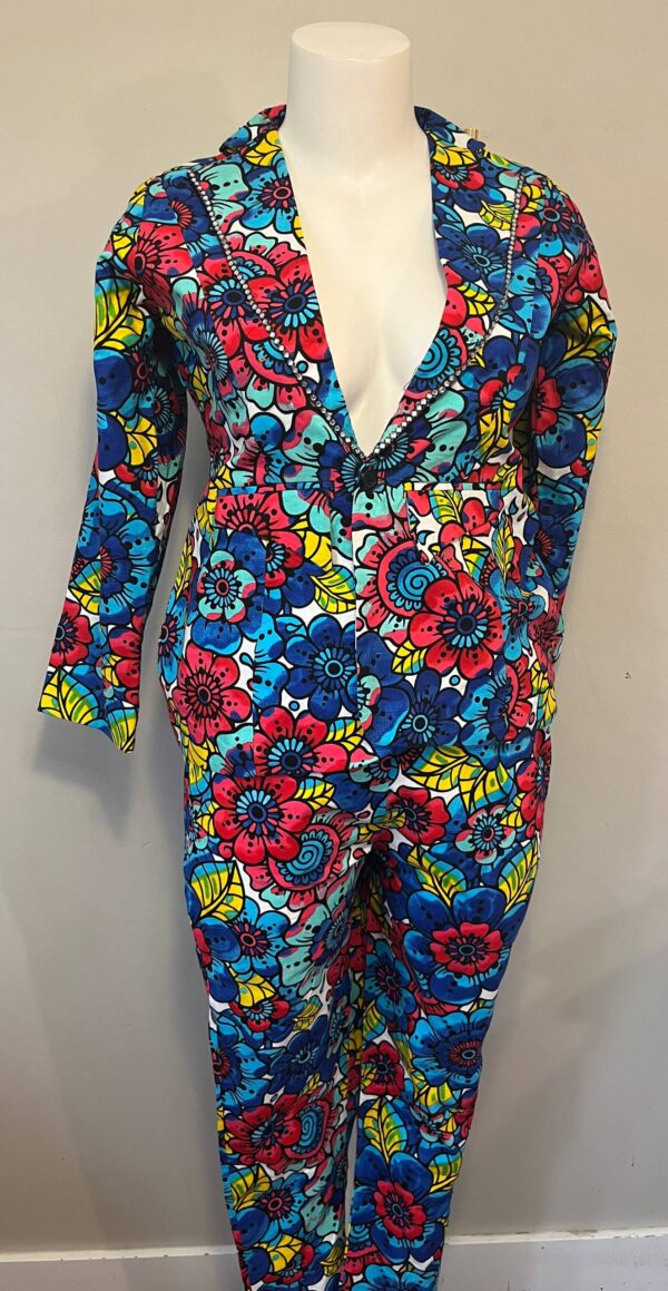Woman’s multicolor Ankara floral blazer and trouser suit with bold blue, red, and yellow African print design